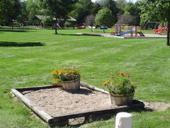 sandbox with playground in background